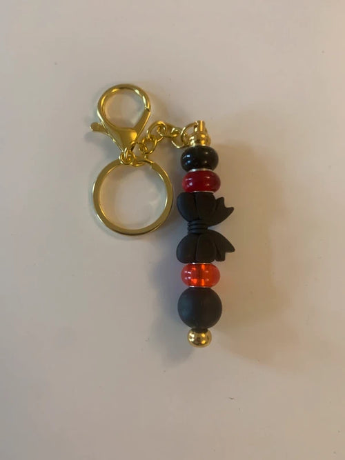 Bijou de sac artisanal porte clé doré gros noeud noir perle silicone verre rouge accessoire chic