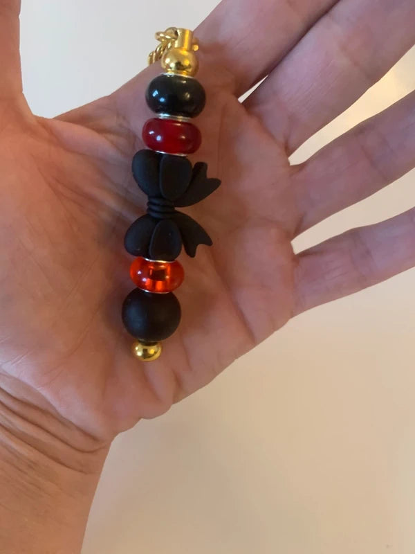 Bijou de sac artisanal porte clé doré gros noeud noir perle silicone verre rouge accessoire chic