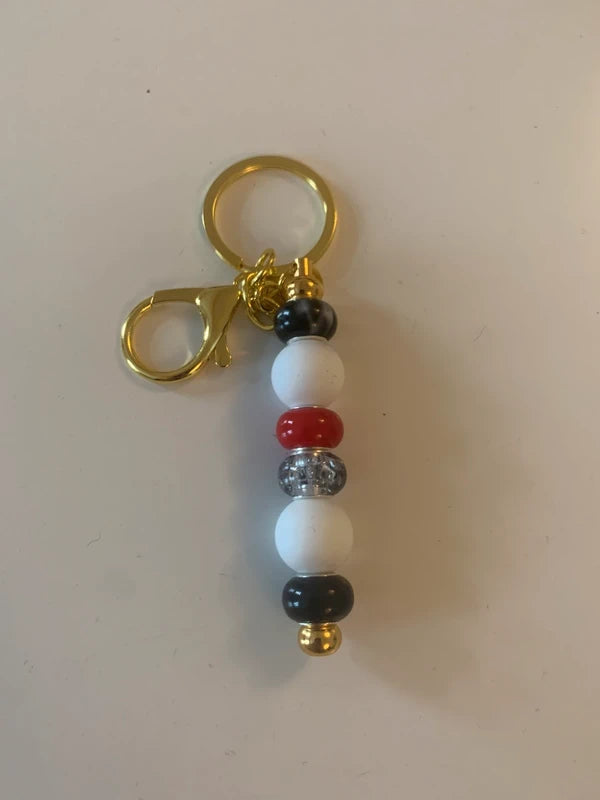 Bijou de sac artisanal porte clé doré perle silicone verre rouge noire brillant élégant chic