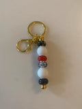 Bijou de sac artisanal porte clé doré perle silicone verre rouge noire brillant élégant chic