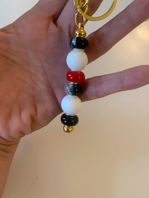 Bijou de sac artisanal porte clé doré perle silicone verre rouge noire brillant élégant chic