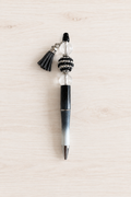 Stylo noir pailleté à perle transparente et pompon