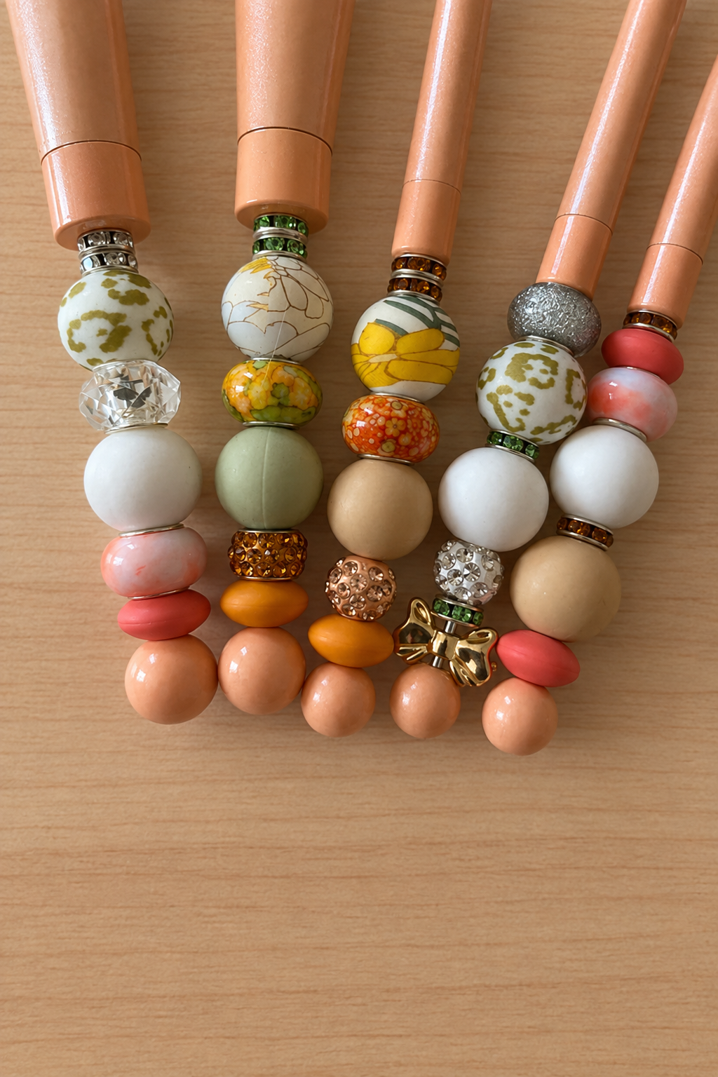 Détail des perles et strass des pinceaux sur bois clair